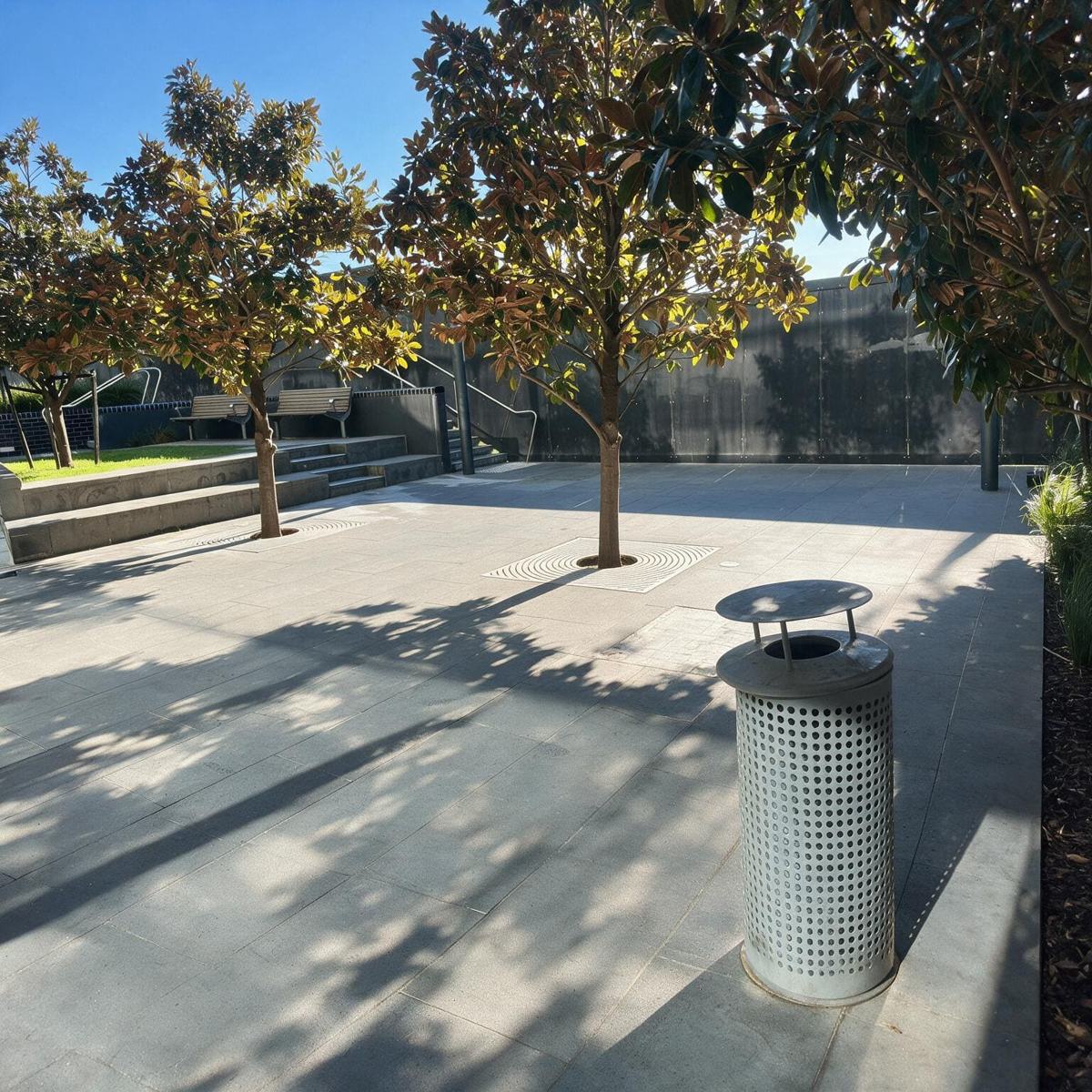 The outdoor courtyard at Drunken Tiger, with trees and a paved seating area